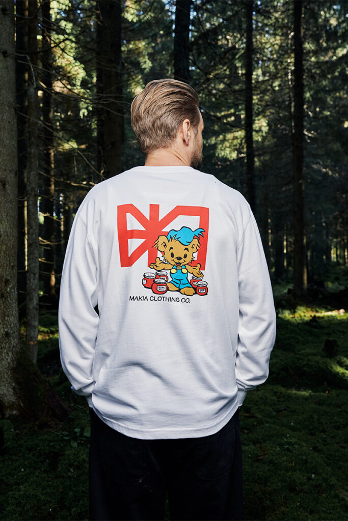 Man standing in forest wearing a grey Bamse Makia sweater