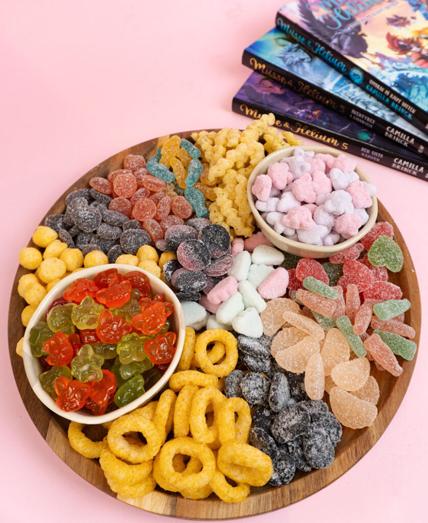 Plate filled with candy and books in the background